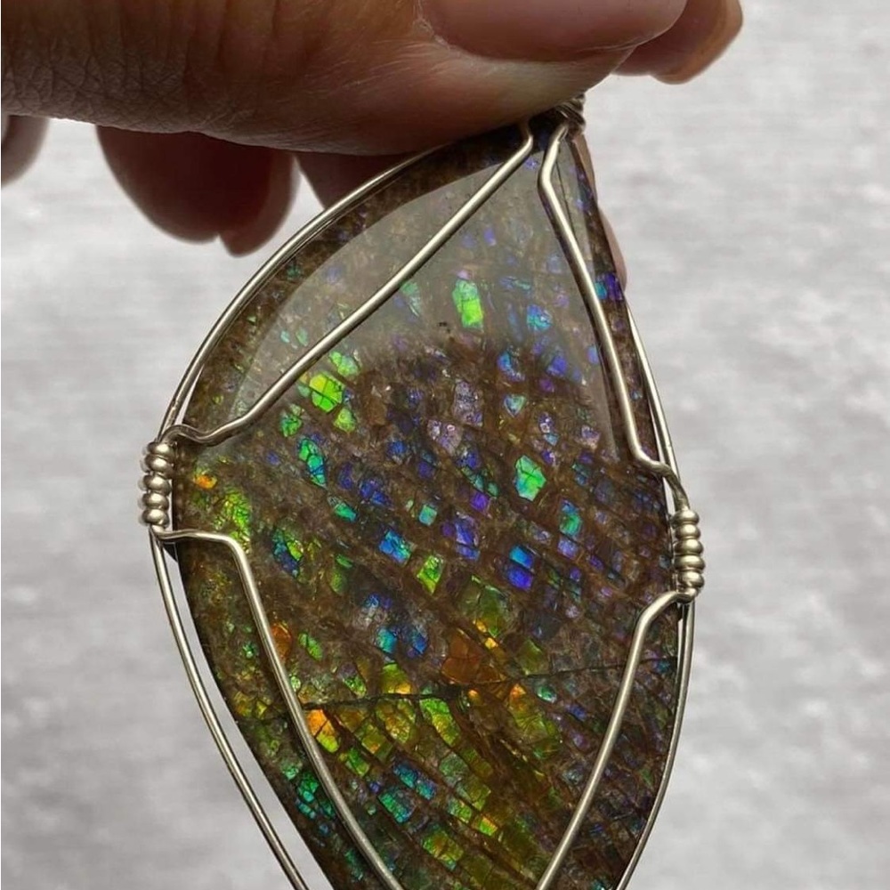 Multi/coloured ammolite pendant - flecks of pink. 2 “ high x 1/2 in wide